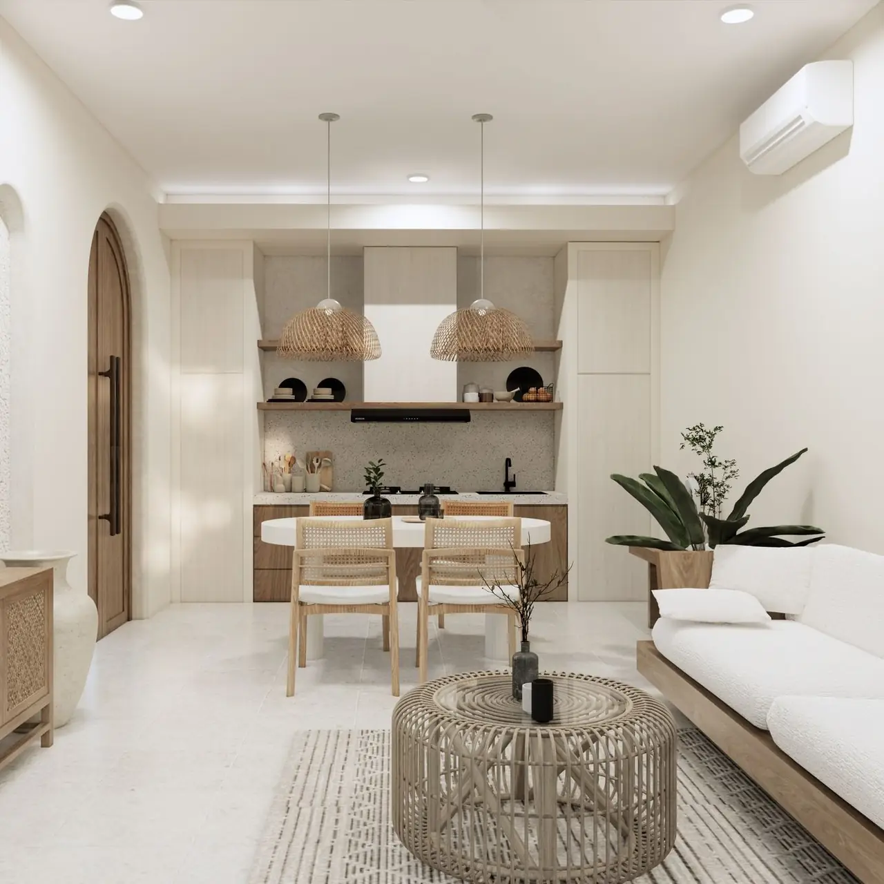 A bright villa living room with a dining table and open kitchen